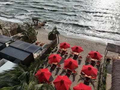 an overhead view of a beach with red umbrellas at Mykonos Beach House Apartamentos By Jerusalema in Tolú