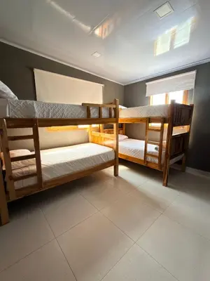 two bunk beds in a room with a window at Mykonos Beach House Apartamentos By Jerusalema in Tolú