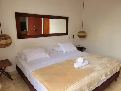 a bedroom with a bed with two towels on it at Apartamentos 129 Casa del Virrey Eslava Centro Histórico in Cartagena de Indias
