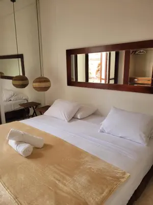 a large white bed with two towels on it at Apartamentos 129 Casa del Virrey Eslava Centro Histórico in Cartagena de Indias