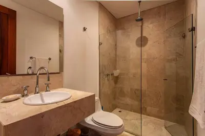 a bathroom with a shower and a toilet and a sink at Apartamentos 129 Casa del Virrey Eslava Centro Histórico in Cartagena de Indias