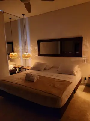 a bedroom with a large bed with a flat screen tv at Apartamentos 129 Casa del Virrey Eslava Centro Histórico in Cartagena de Indias