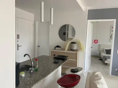 a kitchen with a sink and a red stool at Cartagena Apartamento en Morros en Primera Linea de PLaya in Cartagena de Indias