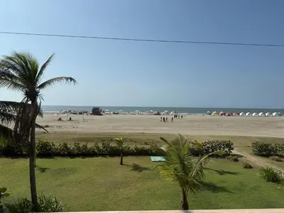 a view of a beach with palm trees and the ocean at Cartagena Apartamento en Morros en Primera Linea de PLaya in Cartagena de Indias