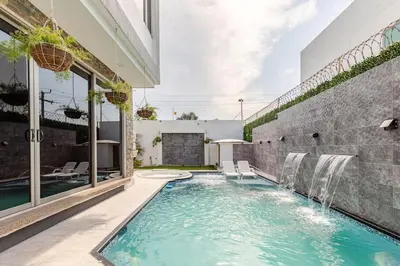 a swimming pool with a waterfall in a house at Studio at the Resort Residence 2 in Puerto Colombia