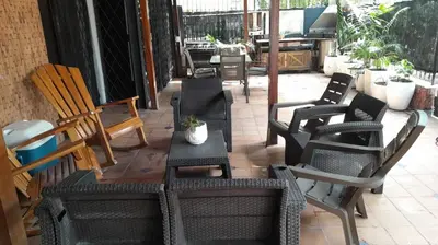 a group of chairs and a table on a patio at Hotel Boutique - Casa Completa en Cartagena de Indias, barrio Castillogrande in Cartagena de Indias