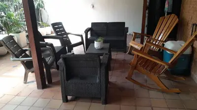 a group of chairs and a table on a patio at Hotel Boutique - Casa Completa en Cartagena de Indias, barrio Castillogrande in Cartagena de Indias