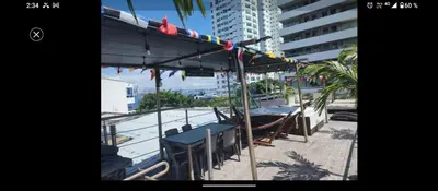 a group of tables and chairs on a balcony at Hotel Boutique - Casa Completa en Cartagena de Indias, barrio Castillogrande in Cartagena de Indias