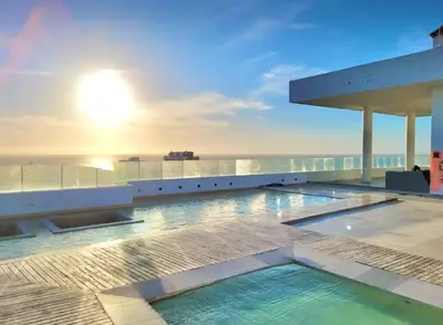 a swimming pool on the roof of a building with the ocean at Great sunsets & sea views, near beach&downtown in Cartagena de Indias