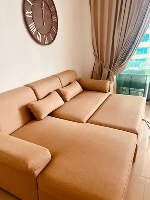 a living room with a couch and a clock on the wall at Morros EPIC OCEAN AND BEACH in Cartagena de Indias