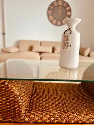 a glass table with a vase on top of it at Morros EPIC OCEAN AND BEACH in Cartagena de Indias