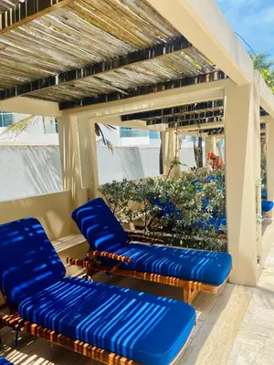 two blue chairs on a patio with a view of the ocean at Morros EPIC OCEAN AND BEACH in Cartagena de Indias