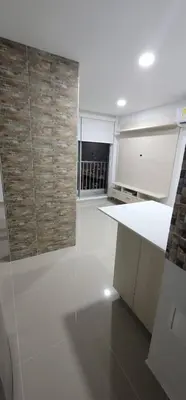 a kitchen with a white counter and a brick wall at Urbis 48 - Piso 23 in Cartagena de Indias