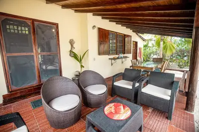 a patio with wicker chairs and a table at ACUARELA in Trementino