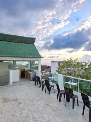 a patio with chairs and a table on a balcony at Casa Playa Boquilla in Cartagena de Indias