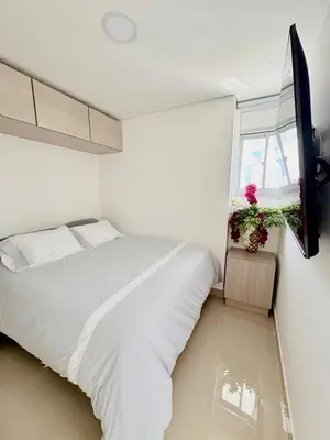 a white bedroom with a bed and a window at Luxury Apartment In Bocagrande With Ocean View 502 in Cartagena de Indias