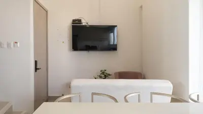 a room with a table and two chairs and a television at Luxury Apartment In Bocagrande With Ocean View 502 in Cartagena de Indias
