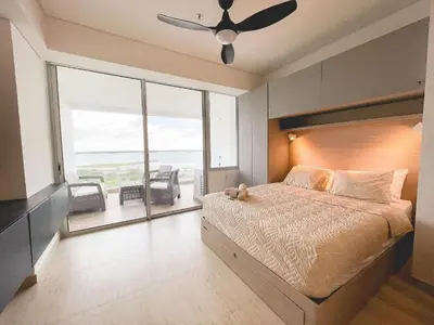 a bedroom with a bed and a view of the ocean at Cartagena Beach Resort in Cartagena de Indias