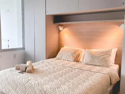 a bedroom with a large bed with a wooden headboard at Cartagena Beach Resort in Cartagena de Indias