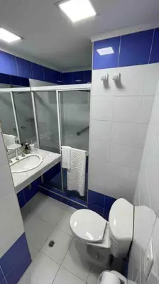 a blue and white bathroom with a toilet and a sink at Vacation Home Apartment in Cartagena in Cartagena de Indias