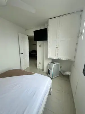 a bedroom with a bed and a small cabinet at Vista al Mar - 77Rentals in Cartagena de Indias