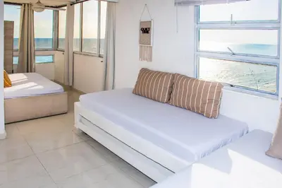 a living room with a couch and a view of the ocean at Vista al Mar - 77Rentals in Cartagena de Indias