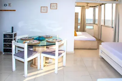 a dining room table with two chairs and a bed at Vista al Mar - 77Rentals in Cartagena de Indias
