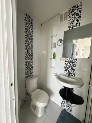 a white bathroom with a toilet and a sink at Vista al Mar - 77Rentals in Cartagena de Indias