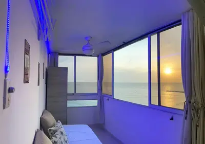 a room with a large window with a view of the ocean at Vista al Mar - 77Rentals in Cartagena de Indias