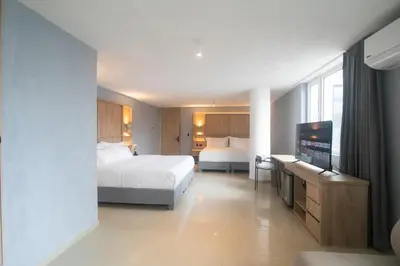 a hotel room with two beds and a flat screen tv at Mood Matuna Hotel Cartagena in Cartagena de Indias