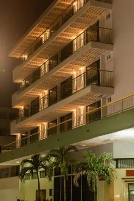 an apartment building with palm trees in front of it at Mood Matuna Hotel Cartagena in Cartagena de Indias