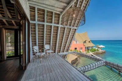a balcony of a house with a view of the ocean at Isla Matamba in Isla Grande