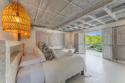 a bedroom with a large bed and a large window at Isla Matamba in Isla Grande