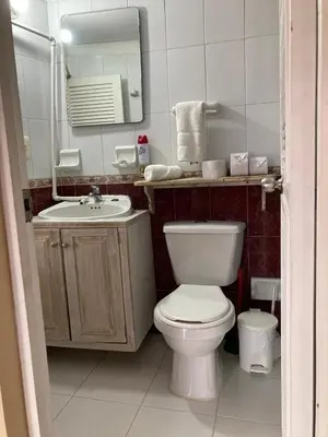 a bathroom with a toilet and a sink and a mirror at Apartamento en la ciudad amurallada cerca de todo in Cartagena de Indias