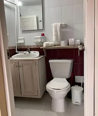 a bathroom with a white toilet and a sink at Apartamento en la ciudad amurallada cerca de todo in Cartagena de Indias