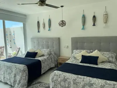 a bedroom with two beds and a ceiling fan at Morros 3 con salida al mar y Piscina in Cartagena de Indias