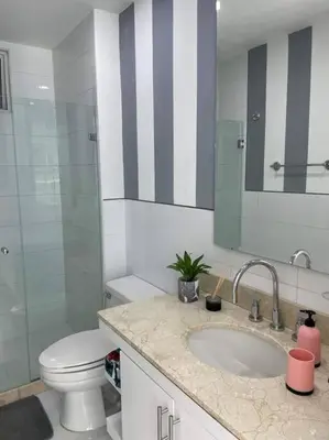 a bathroom with a sink and a toilet and a mirror at Morros 3 con salida al mar y Piscina in Cartagena de Indias
