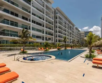 a large apartment building with a swimming pool and a resort at Morros 3 con salida al mar y Piscina in Cartagena de Indias