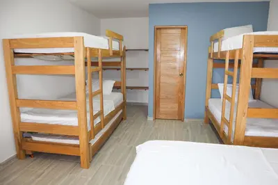 a room with three bunk beds and a bed at Apartamento Villa Carolina 101 in San Antero