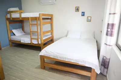 a room with two beds and a bunk bed at Apartamento Villa Carolina 101 in San Antero