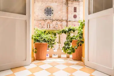 an open door with potted plants in front of a building at Casa en la mejor plaza de la ciudad vieja in Cartagena de Indias