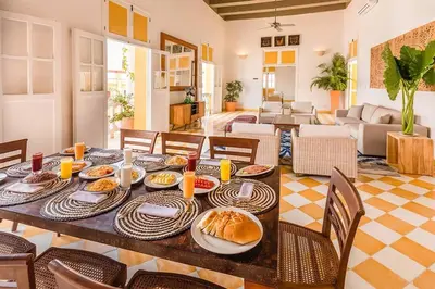 a table with food on it in a living room at Casa en la mejor plaza de la ciudad vieja in Cartagena de Indias