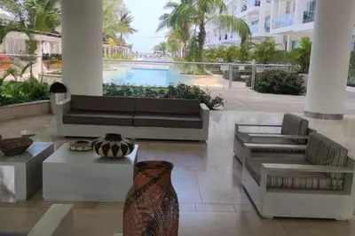 a lobby with a couch and chairs and a pool at Apartamento en Cartagena de Indias, Edificio Morros 3 in Cartagena de Indias