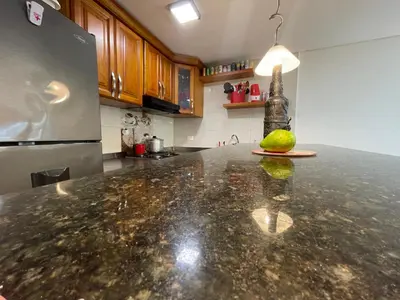 a kitchen with a granite counter top with a lime on the counter at Casa Boutique Rincon in San Onofre