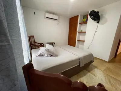 a small room with a bed and a fan at Casa Boutique Rincon in San Onofre