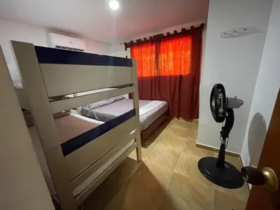 a bedroom with two bunk beds and a fan at Casa Boutique Rincon in San Onofre