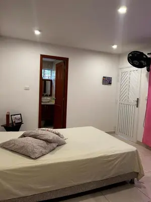 a bedroom with a bed and a door to a bathroom at Casa Boutique Rincon in San Onofre