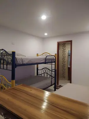 a room with two bunk beds and a table at Casa Boutique Rincon in San Onofre