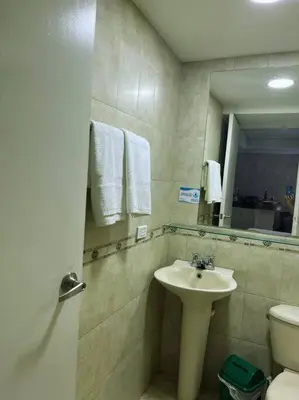 a bathroom with a sink and a toilet and a mirror at Beach retreat in El Laguito in Cartagena de Indias