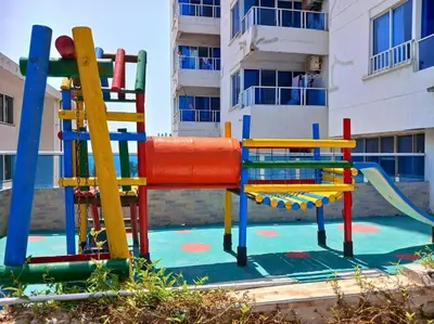 a playground with a slide in front of a building at Beach retreat in El Laguito in Cartagena de Indias
